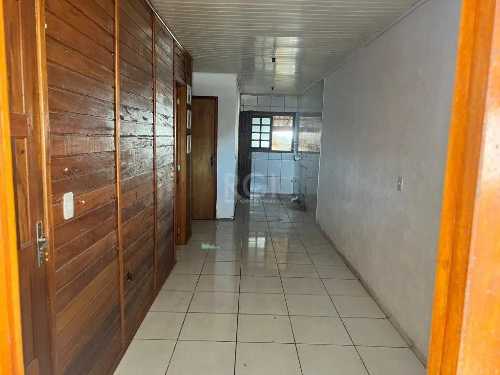 Imagem Terreno de 392m² com casa mista de 82m²