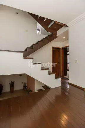 Imagem Casa em Condomínio 3 dorms à venda Avenida Vicente Monteggia, Cavalhada - Porto Alegre