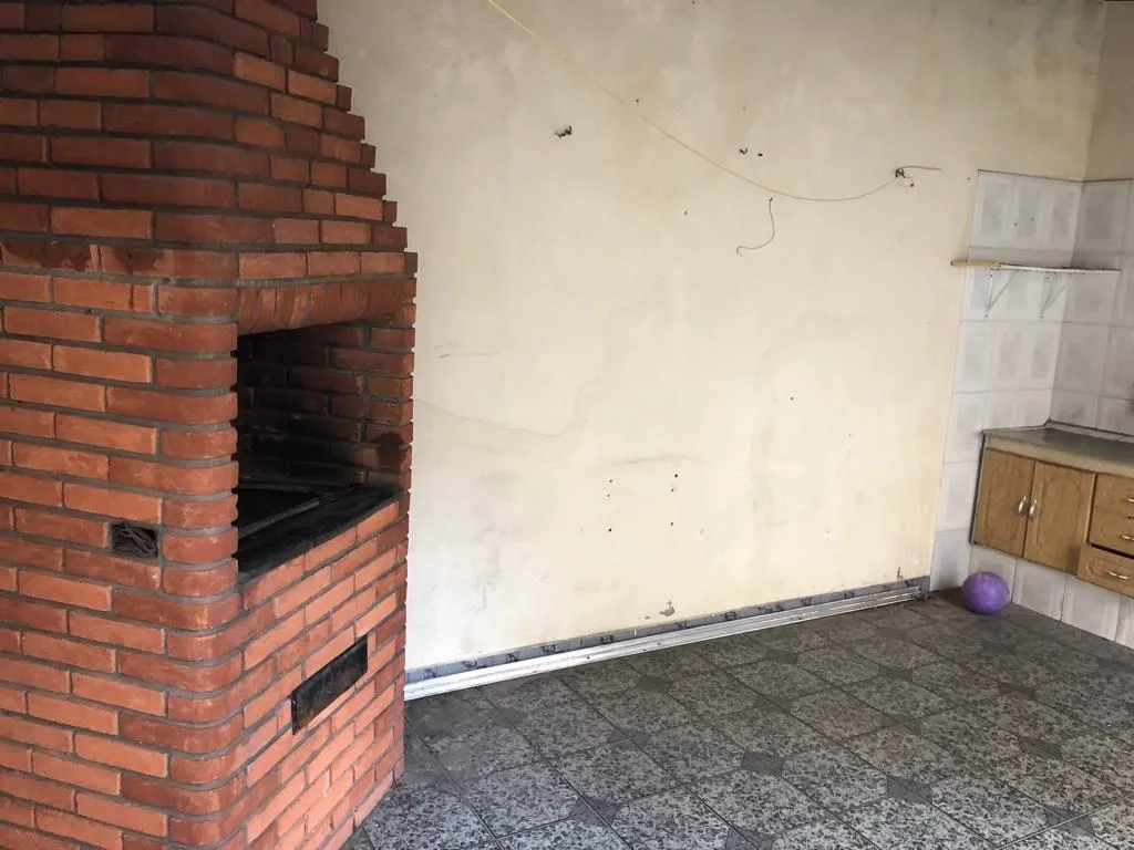 Imagem Sobrado à Venda no Jardim das Flores: 2 Suítes, Churrasqueira e Quintal