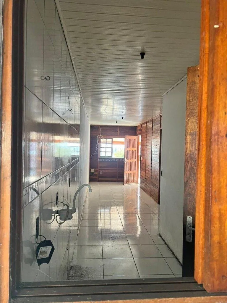 Imagem Terreno de 392m² com casa mista de 82m²
