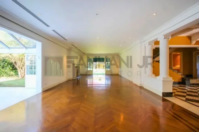 Imagem Luxuosa casa de alto padrão de 4 suítes no Jardim América: 6 salas, 8 banheiros, 12 vagas de garagem e 1.029m² de área em SP.