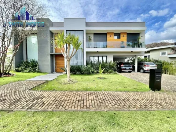 Imagem CASA À VENDA DE PORTEIRA FECHADA! Impecável, 4 suítes, elevador, piscina