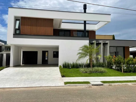 Imagem Casa nova com 4 suítes e 4 vagas privativas de garagem em condomínio fechado em Camboriú/SC