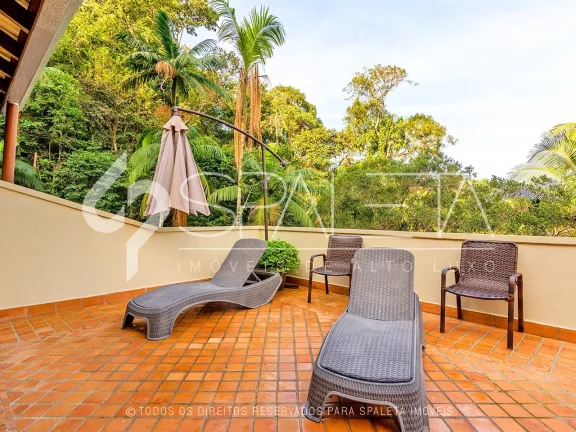 Imagem Aprecie o luxo e a tranquilidade no condomínio Iporanga, Guarujá: Casa exclusiva com ambientes espaçosos e vista deslumbrante