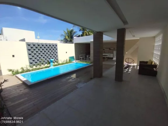Imagem Casa de Alto Padrão na Aruana: 5 quartos, 4 suítes, posição Leste - Confira!